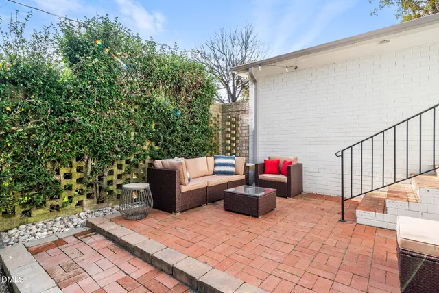 a view of a workspace with furniture and a ceiling fan