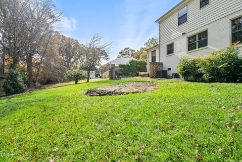 a view of a swimming pool with a yard and seating area