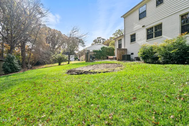 a view of a swimming pool with a yard and seating area
