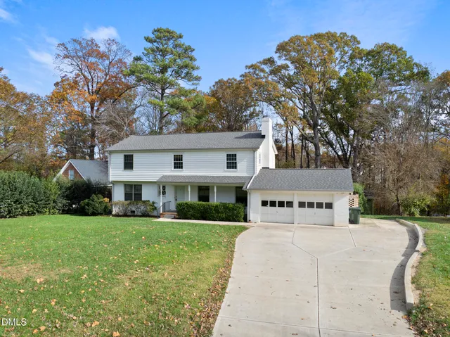 an aerial view of a house with yard swimming pool and lake view