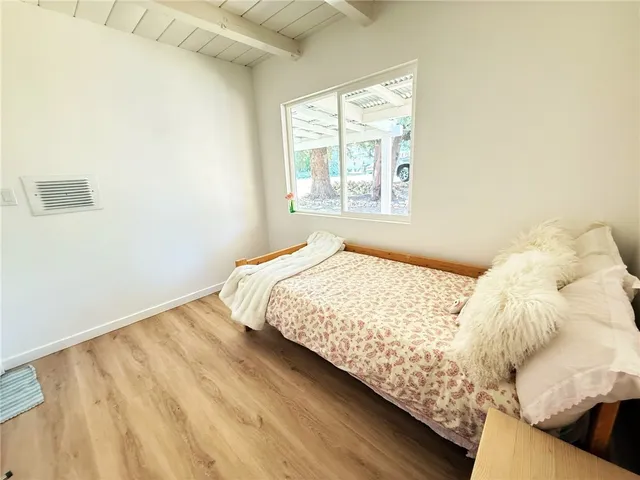 a bedroom with bed and a window