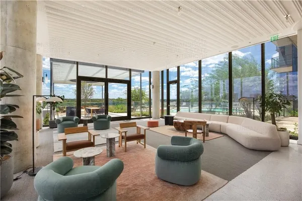 a view of a patio with table and chairs and a barbeque