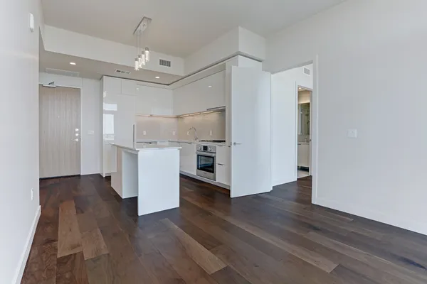a view of a room with wooden floor and windows