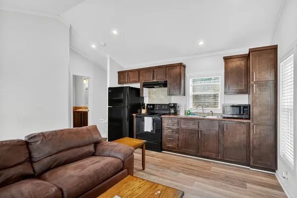 a kitchen with stainless steel appliances granite countertop a refrigerator a stove and a sink