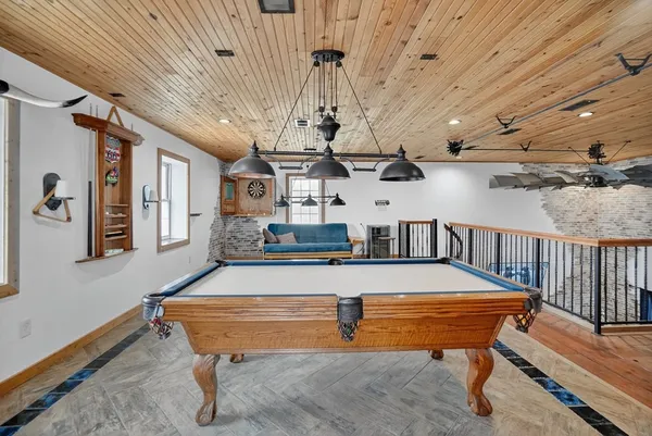 a room with stainless steel appliances lots of furniture