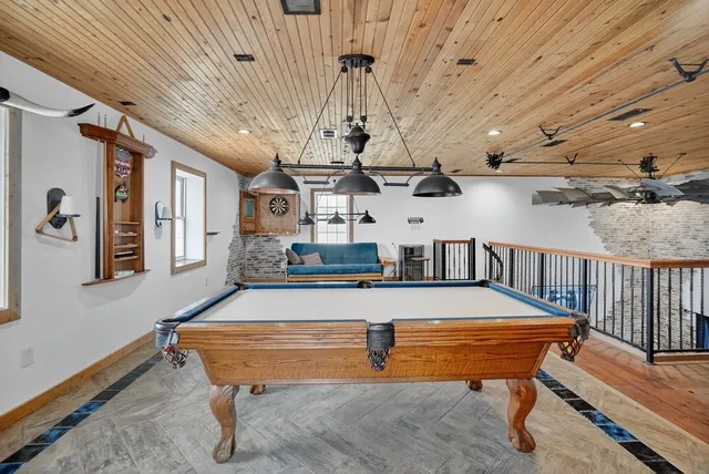 a room with stainless steel appliances lots of furniture