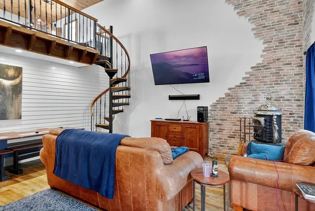 a bedroom with a bed and flat screen tv