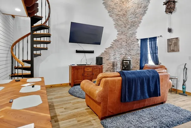 a living room with furniture ceiling fan and a fireplace
