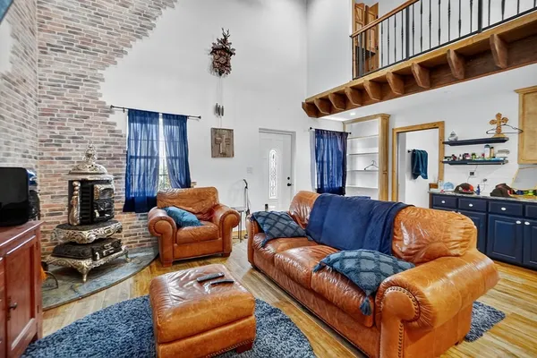 a living room with furniture kitchen view and a large window