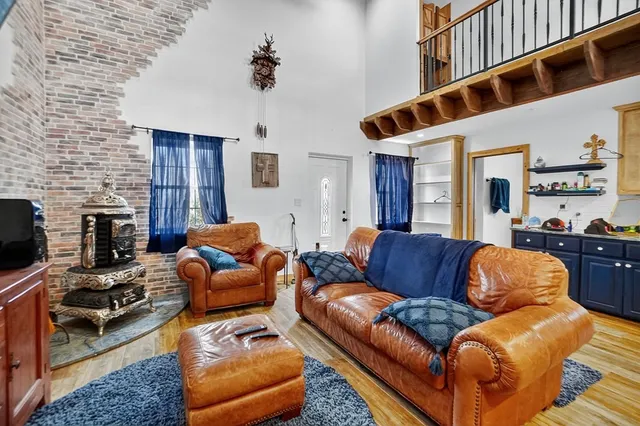 a living room with furniture kitchen view and a large window
