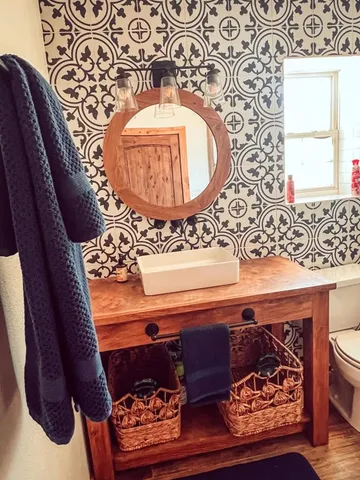 a bathroom with a sink a mirror and shower curtain