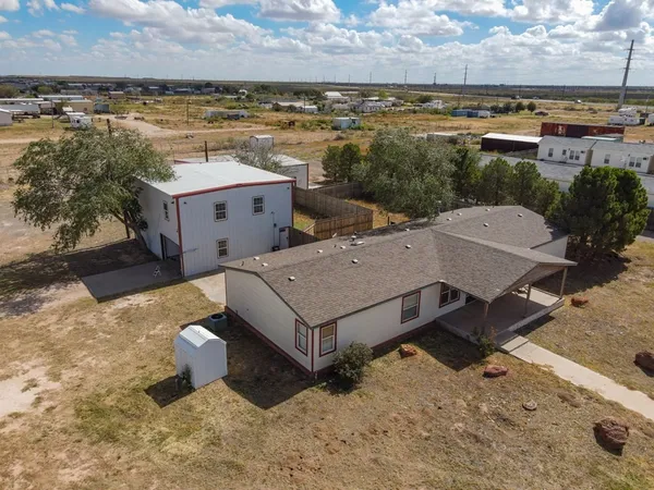 an aerial view of a house with a yard