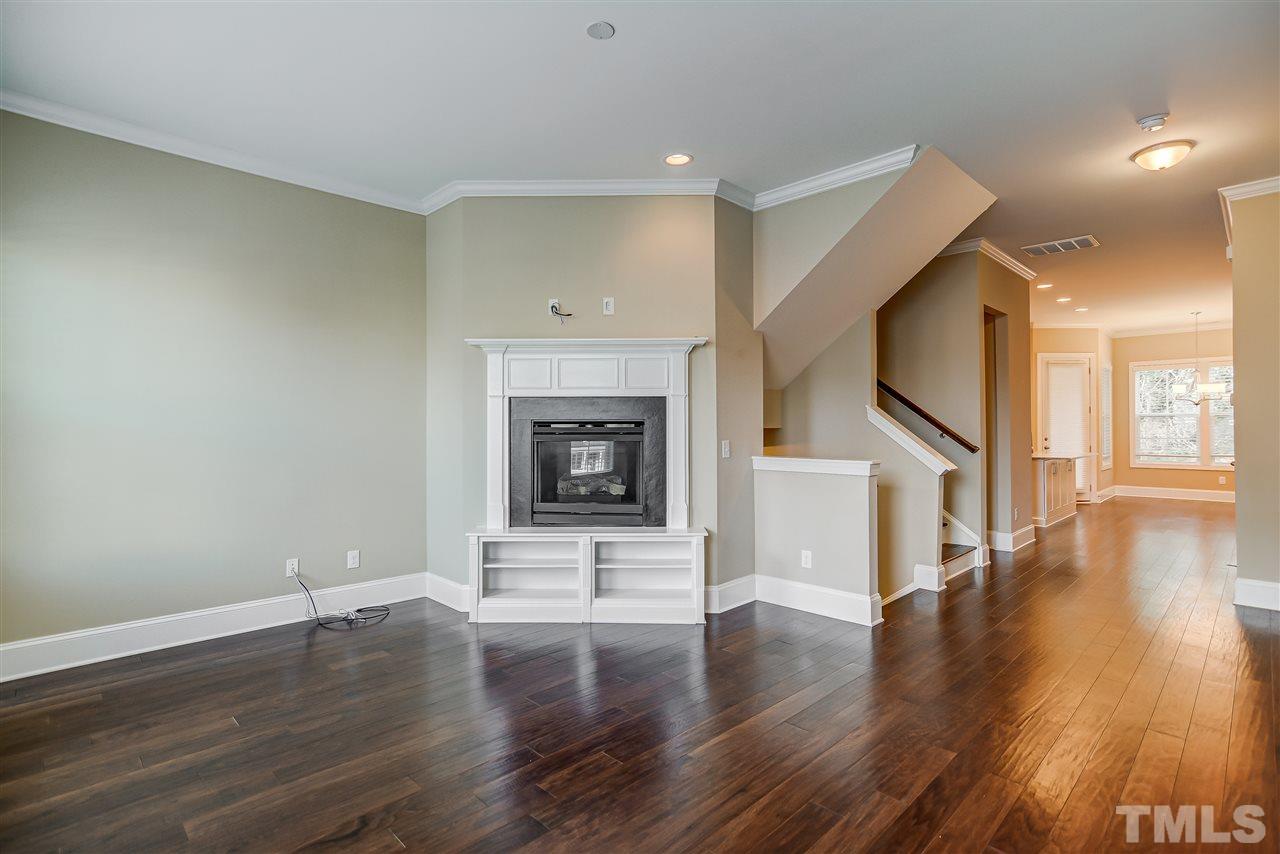 3606 Winifred Way Raleigh, NC 27609 - Photo 2 of 18 a view of a livingroom with wooden floor and a fireplace