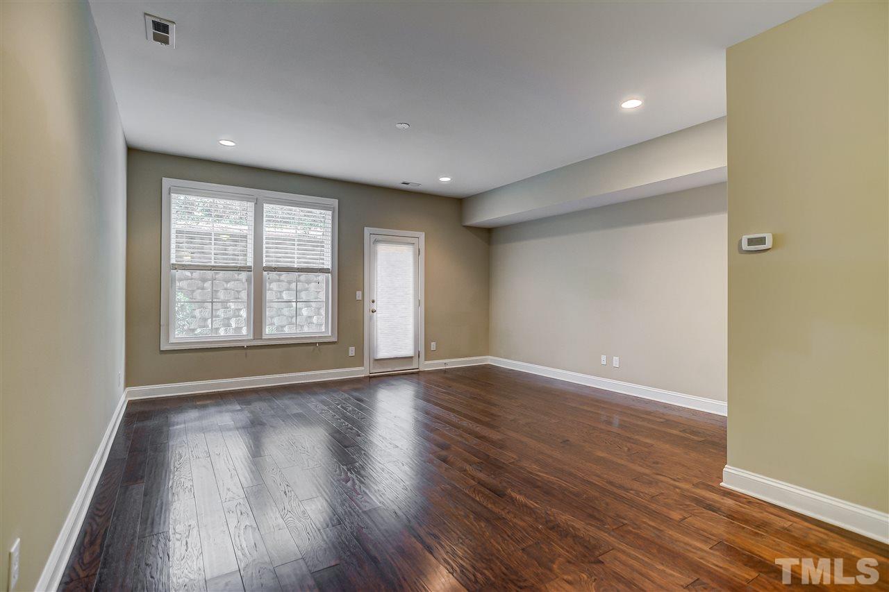 3606 Winifred Way Raleigh, NC 27609 - Photo 14 of 18 a view of an empty room with wooden floor and a window