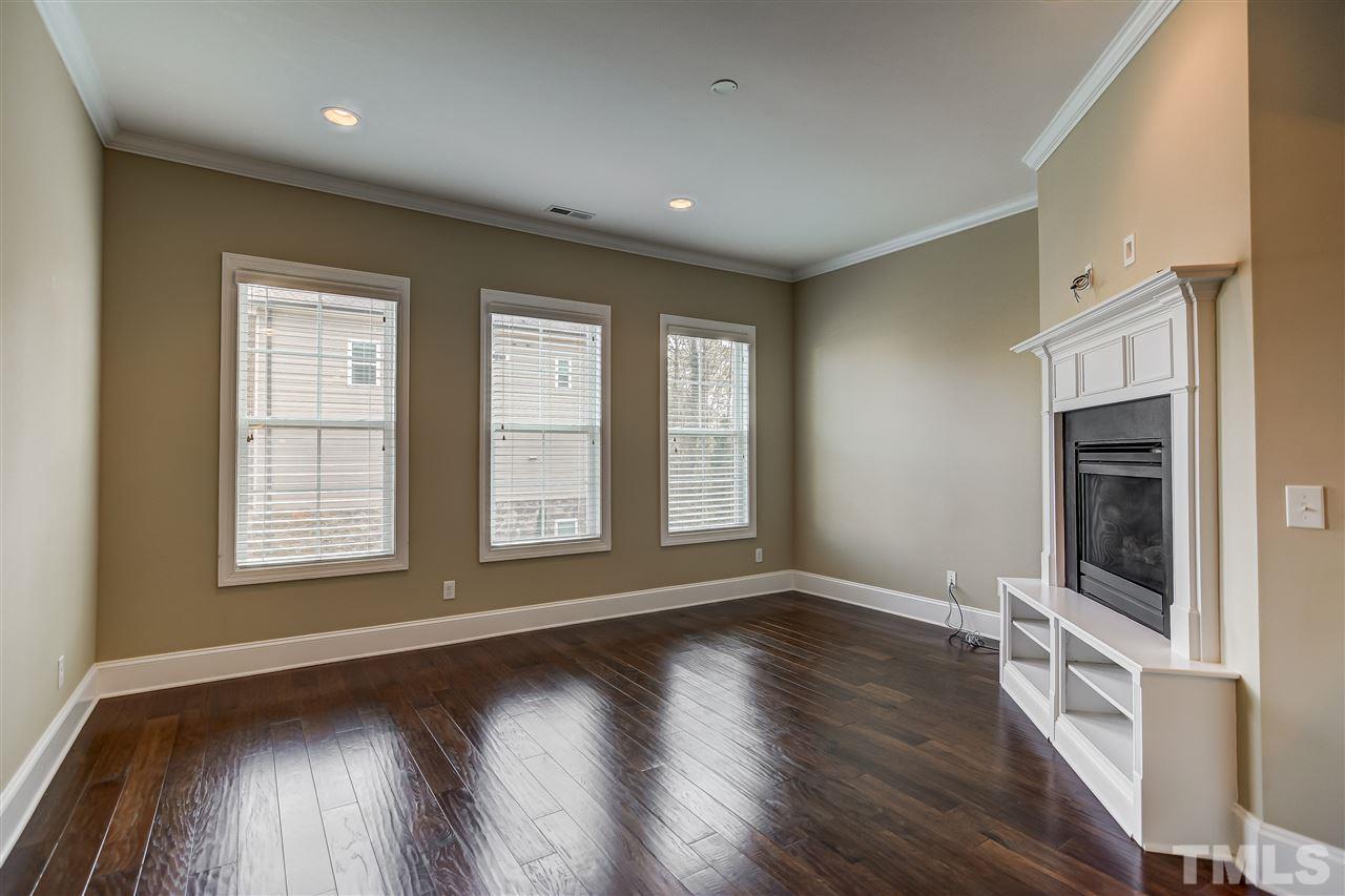3606 Winifred Way Raleigh, NC 27609 - Photo 3 of 18 a view of an empty room with a fireplace and a window