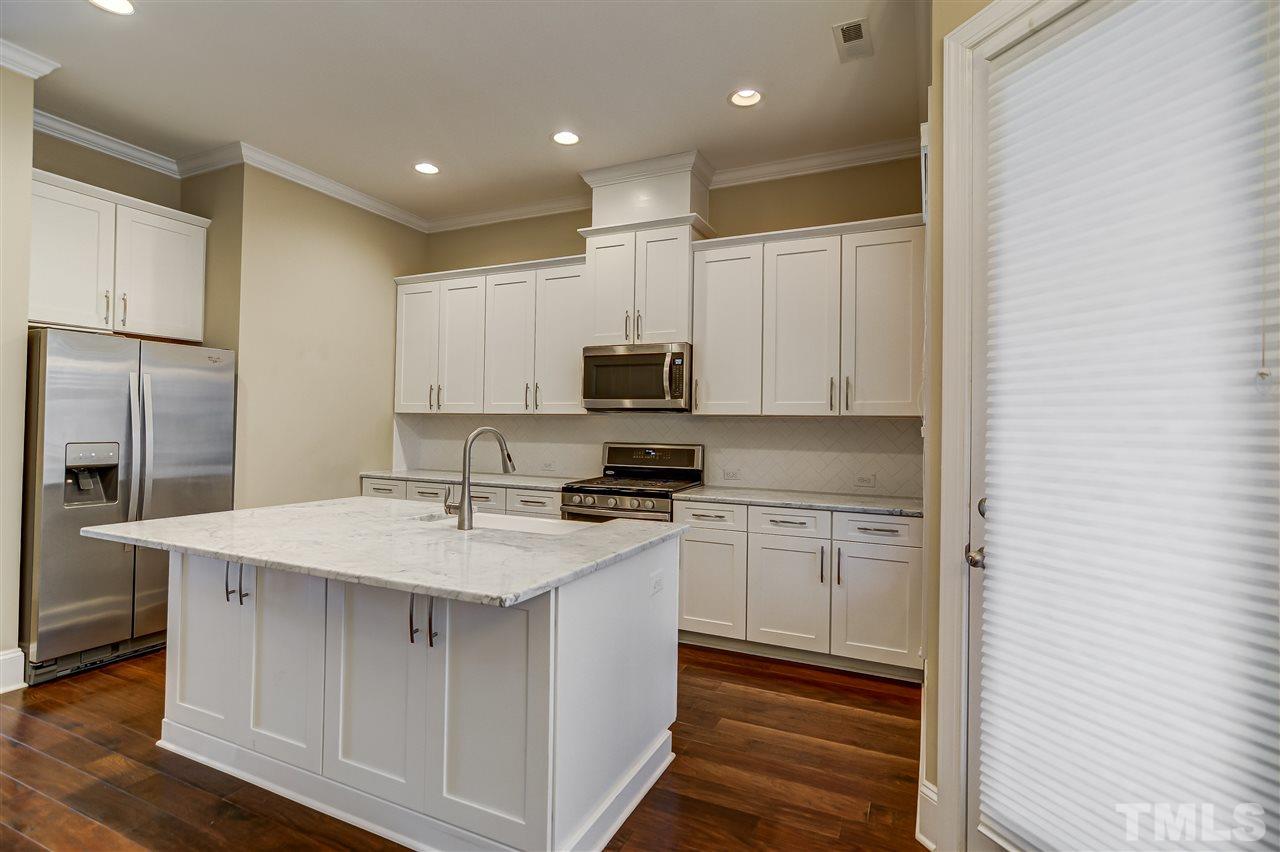 3606 Winifred Way Raleigh, NC 27609 - Photo 4 of 18 a kitchen with stainless steel appliances granite countertop a stove a sink and a refrigerator