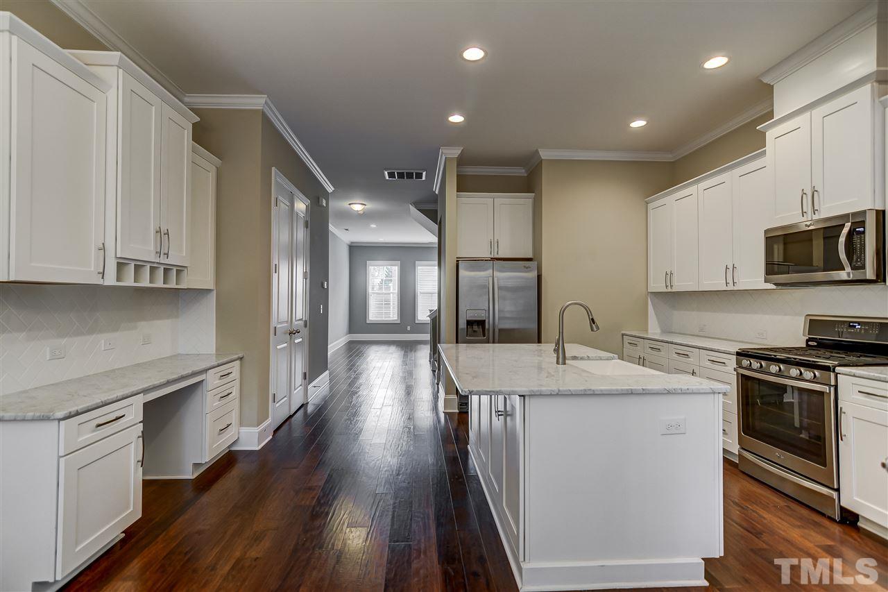 3606 Winifred Way Raleigh, NC 27609 - Photo 6 of 18 a kitchen with stainless steel appliances granite countertop a sink stove and cabinets