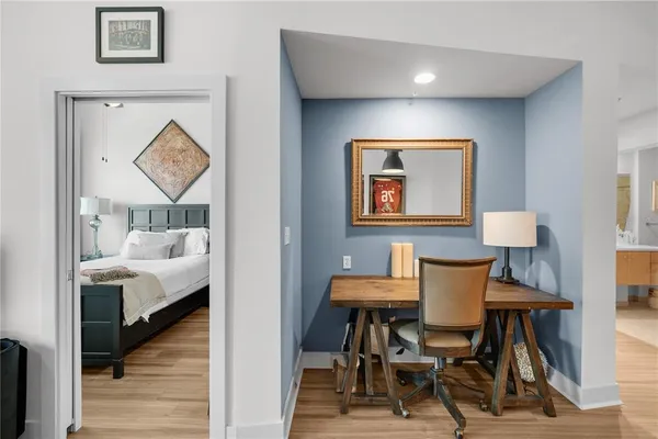 a view of a room with furniture and wooden floor