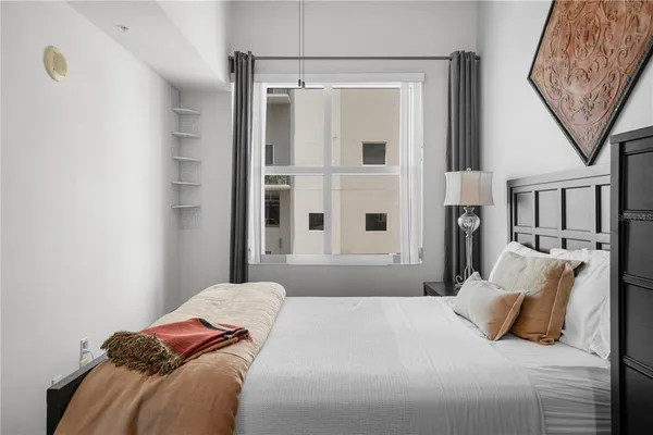 a bedroom with a large bed and a window