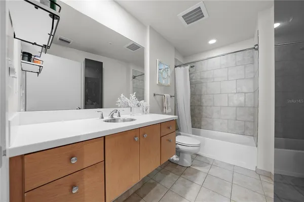 a bathroom with a double vanity sink toilet and shower