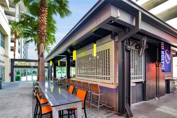 a view of a patio with table and chairs with wooden floor and fence