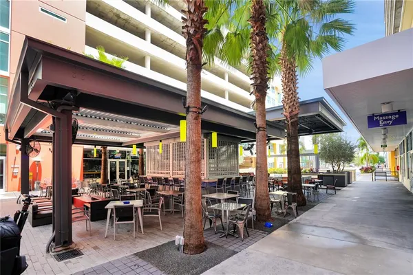 an outdoor space with lots of tables and chairs