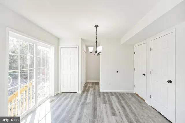 a view of a room with wooden floor and windows