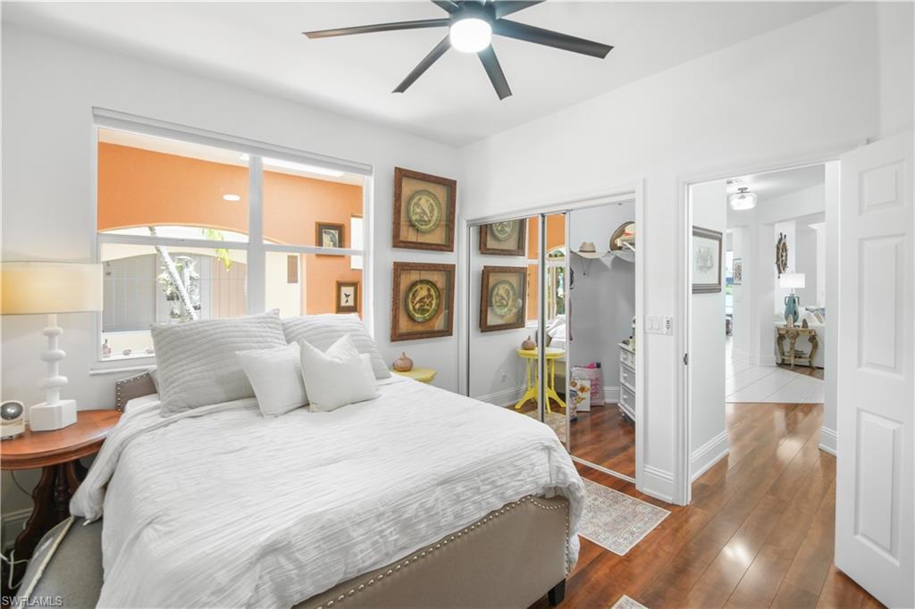 172 Eveningstar Cay Naples, FL 34114 - Photo 12 of 24 a bedroom with a large bed and a large window