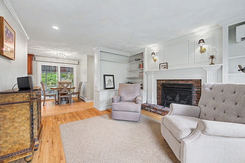 1 Coburn Road Hopkinton, MA 01748 - Photo 15 of 42 a living room with furniture a fireplace and a large window