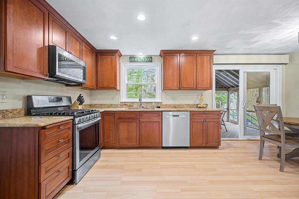 1 Coburn Road Hopkinton, MA 01748 - Photo 4 of 42 a kitchen with stainless steel appliances granite countertop wooden cabinets a sink and a stove