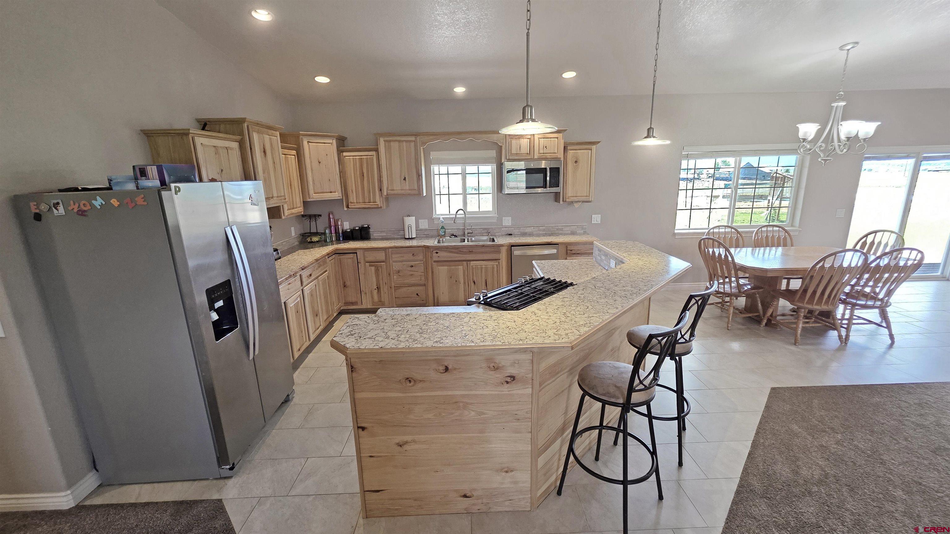 26030 Road North Cortez, CO 81321 - Photo 14 of 39 a view of a dining room with furniture window and wooden floor