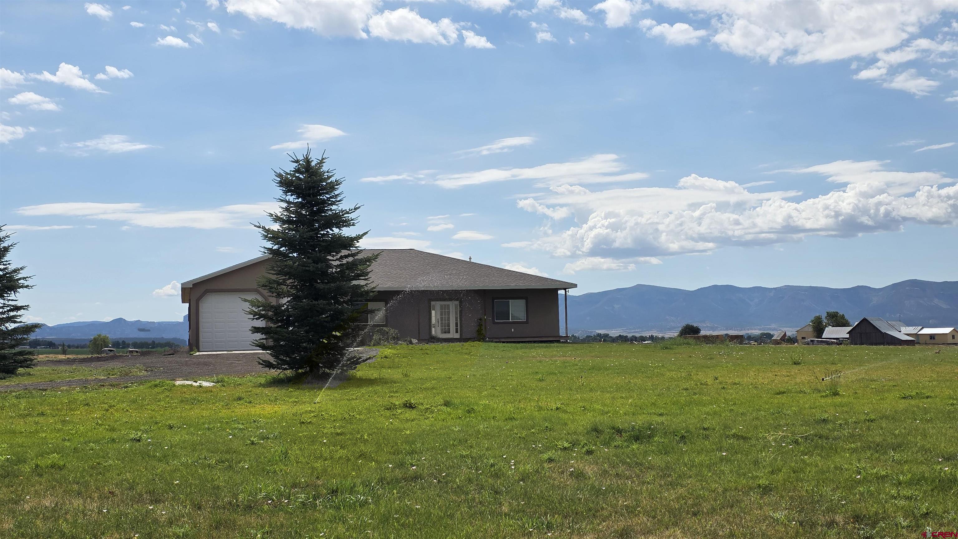 26030 Road North Cortez, CO 81321 - Photo 3 of 39 a front view of a house with garden