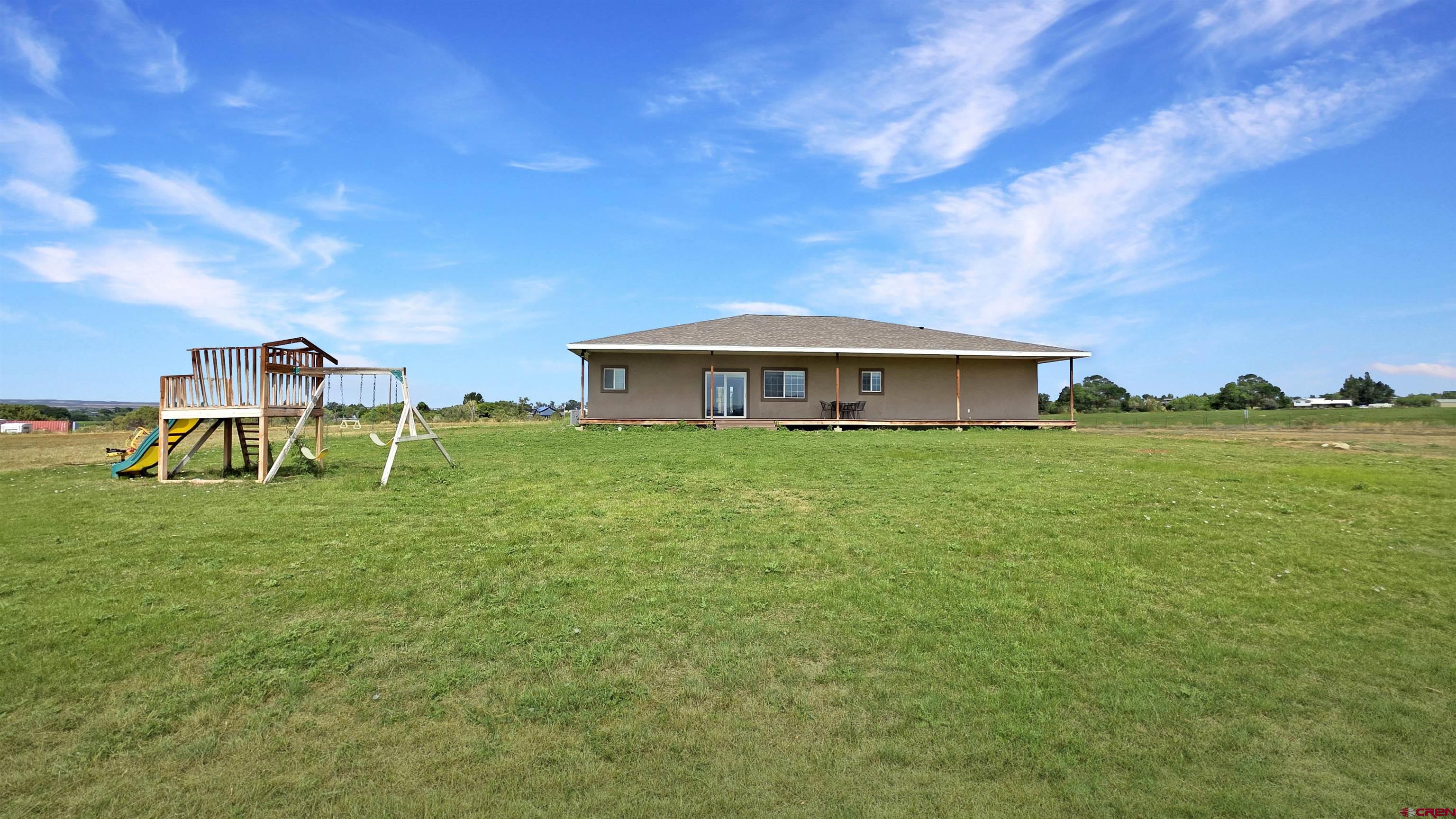 26030 Road North Cortez, CO 81321 - Photo 34 of 39 a view of an house with backyard space and balcony