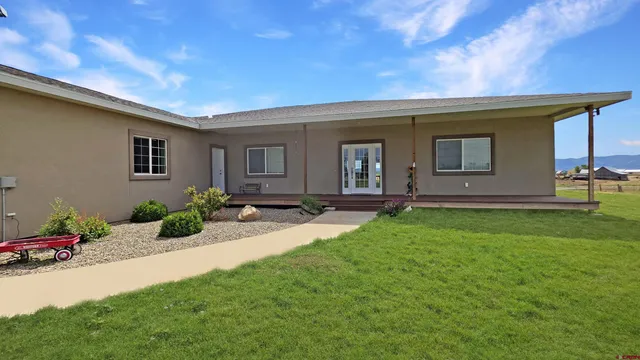 a large kitchen with stainless steel appliances granite countertop a sink and cabinets