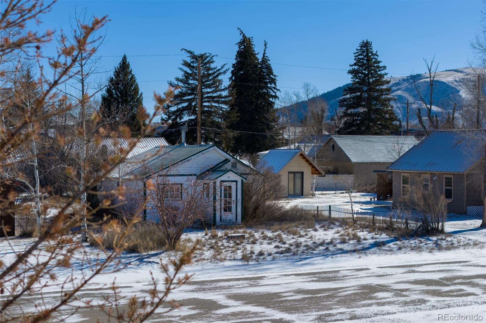 212 5th Street Kremmling, CO 80459 - Photo 3 of 10 a front view of a house with garden