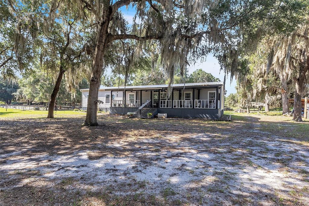 601 Purvis Road Seville, FL 32190 - Photo 29 of 29 a view of a house with backyard and a tree
