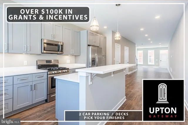 a kitchen with kitchen island white cabinets and refrigerator