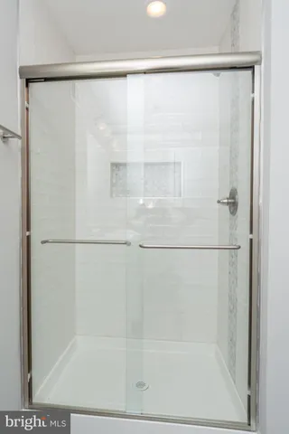 a bathroom with a glass shower door