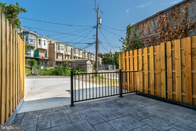 a front view of a house with iron gate