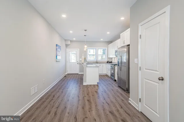a view of a kitchen with wooden floor