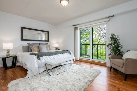 a spacious bedroom with a bed and a large window