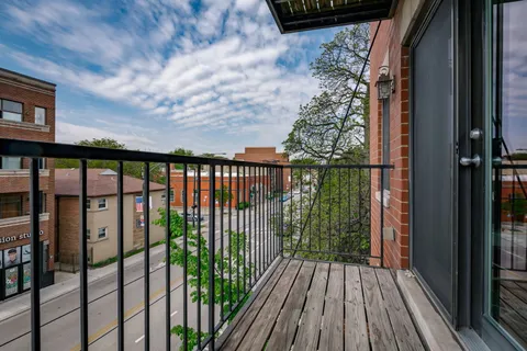a view of balcony with wooden floor