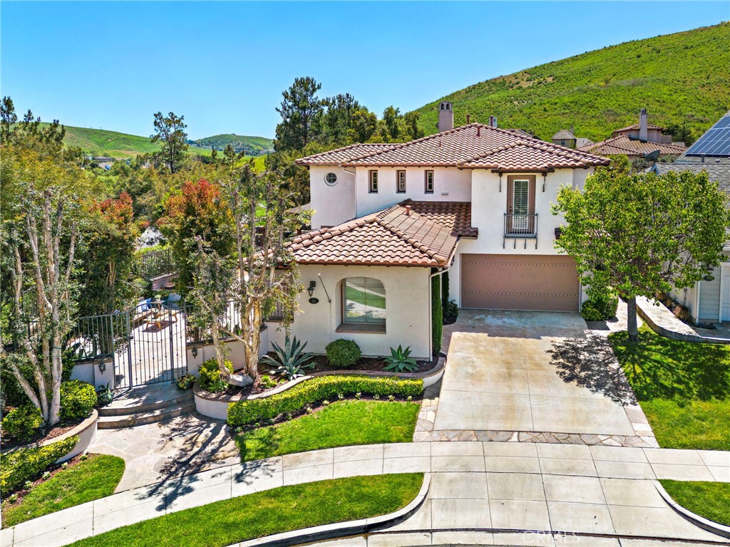 12 Calliandra Street Ladera Ranch, CA 92694 - Photo 1 of 1 a front view of a house with a yard and potted plants