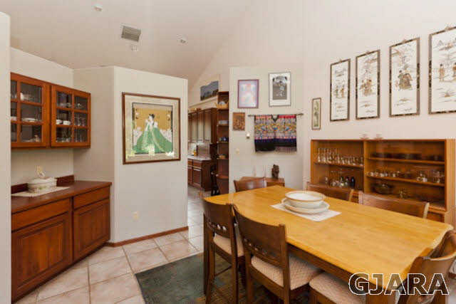 2334 Sundial Road Grand Junction, CO 81505 - Photo 11 of 31 a kitchen with stainless steel appliances granite countertop a stove a refrigerator a sink a dining table and chairs with wooden floor