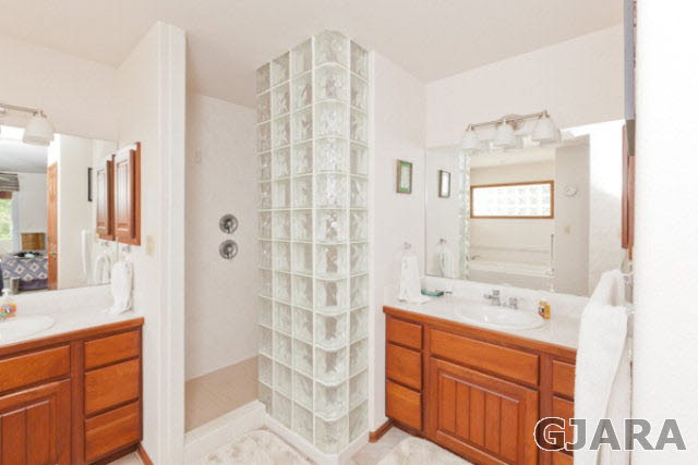 2334 Sundial Road Grand Junction, CO 81505 - Photo 18 of 31 a bathroom with a double vanity sink mirror and shower