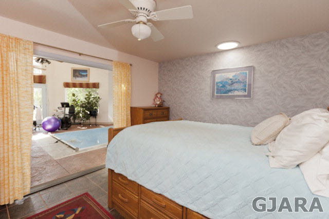 2334 Sundial Road Grand Junction, CO 81505 - Photo 22 of 31 a bedroom with a large bed and a chandelier