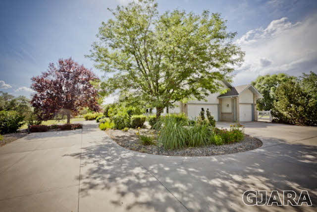 2334 Sundial Road Grand Junction, CO 81505 - Photo 24 of 31 a front view of a house with a yard and a garage