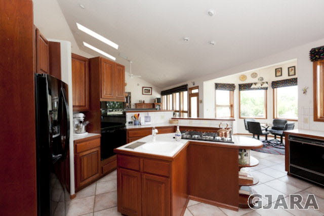 2334 Sundial Road Grand Junction, CO 81505 - Photo 7 of 31 a kitchen with a refrigerator a stove a sink dishwasher with a dining table and chairs