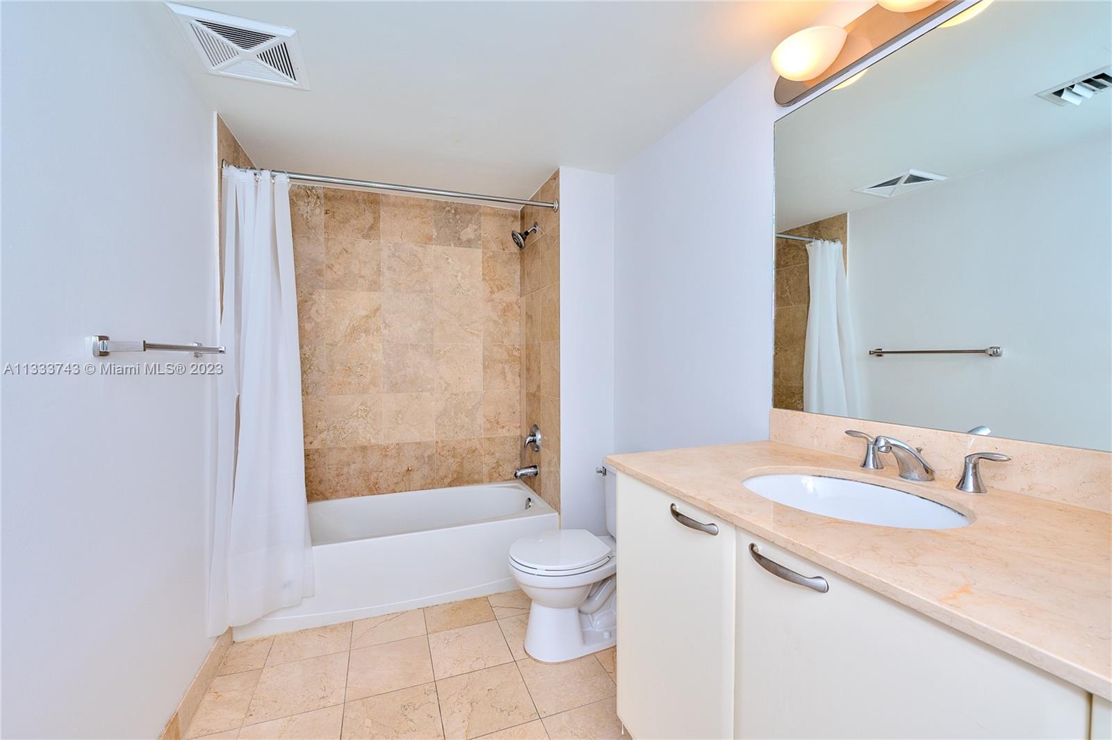 Brickell Miami, FL 33129 - Photo 12 of 44 a bathroom with a granite countertop sink a toilet and shower