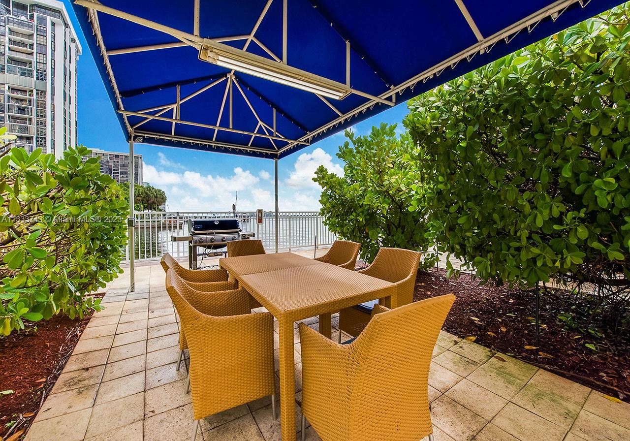 Brickell Miami, FL 33129 - Photo 25 of 44 a patio with a table and chairs under an umbrella
